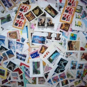 Collection of assorted postage stamps scattered around.