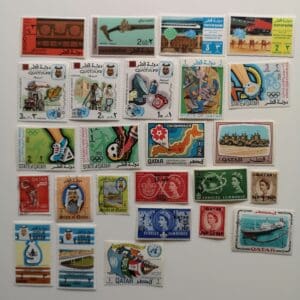 Collection of colorful vintage Qatar stamps.