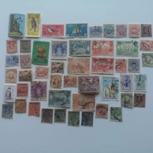 Assorted vintage postage stamps on white background
