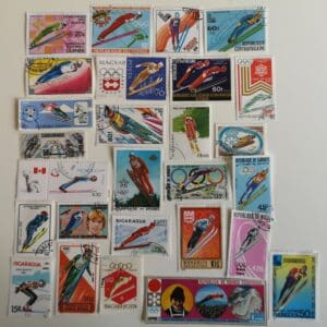 Collection of vintage ski-themed postage stamps.