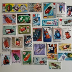 Collection of vintage bobsled-themed postage stamps.