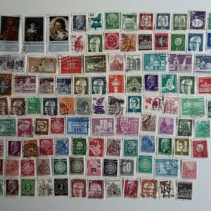 Assorted colorful postage stamps arranged on white