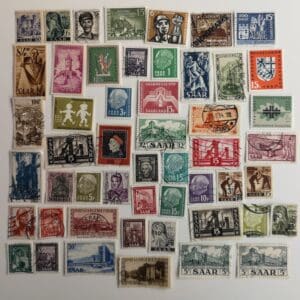 Assorted vintage Saar postage stamps on white