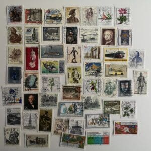 Assorted vintage postage stamps on white background