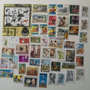 Assorted colorful vintage postage stamps on white